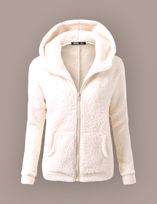 She Is Warm cream-colored fuzzy hooded jacket with a front zipper and kangaroo pockets, made of soft polyester fleece.